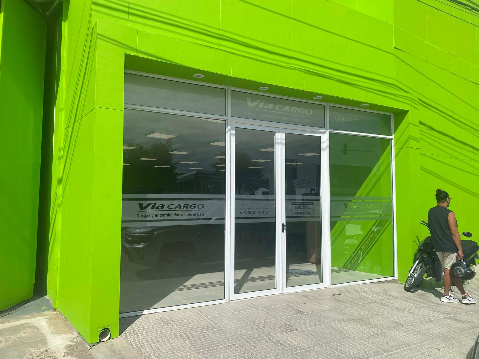 fachada de local comercial verde lima con vidrios amplios — proyecto Sucursal Via Cargo, filial Corrientes, Empresa de distribución y logística., por Arquitecto Gustavo Maidana, en