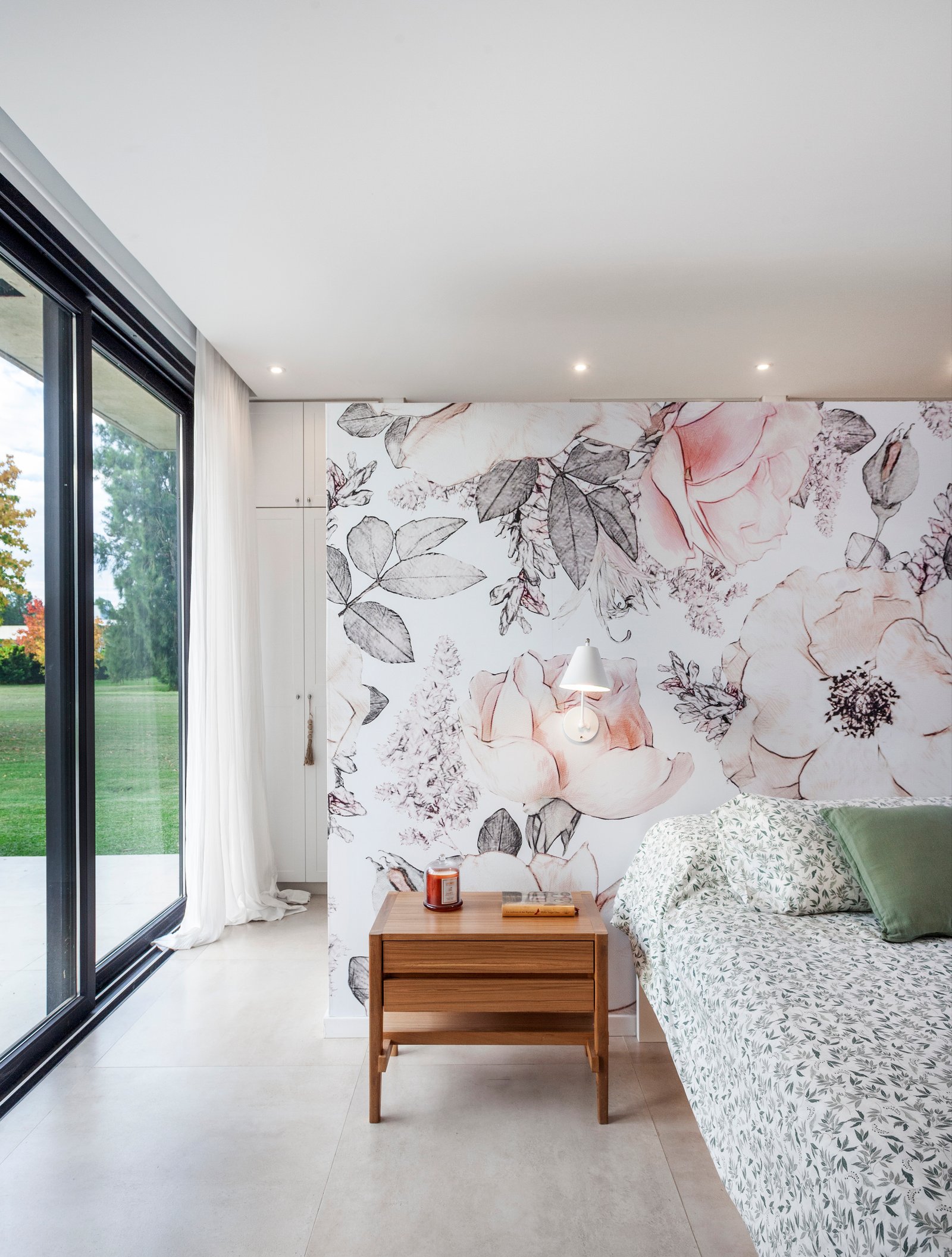 Dormitorio moderno con papel mural floral y ventana de piso a techo — proyecto CASA HS143, por A'PRIMA - Arquitectura Sustentable, en km 7.5 Ruta 25