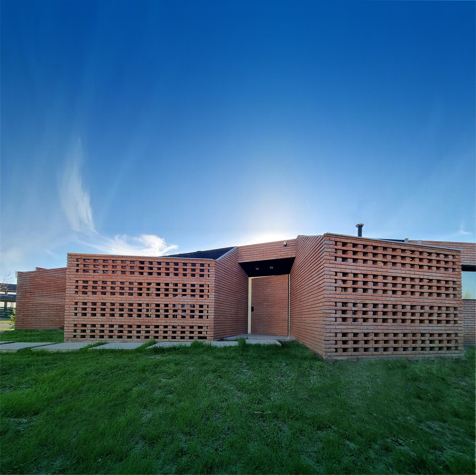 fachada de ladrillo perforado moderno en entorno rural — proyecto SS01-House, por Etunez, en Provincia de Buenos Aires