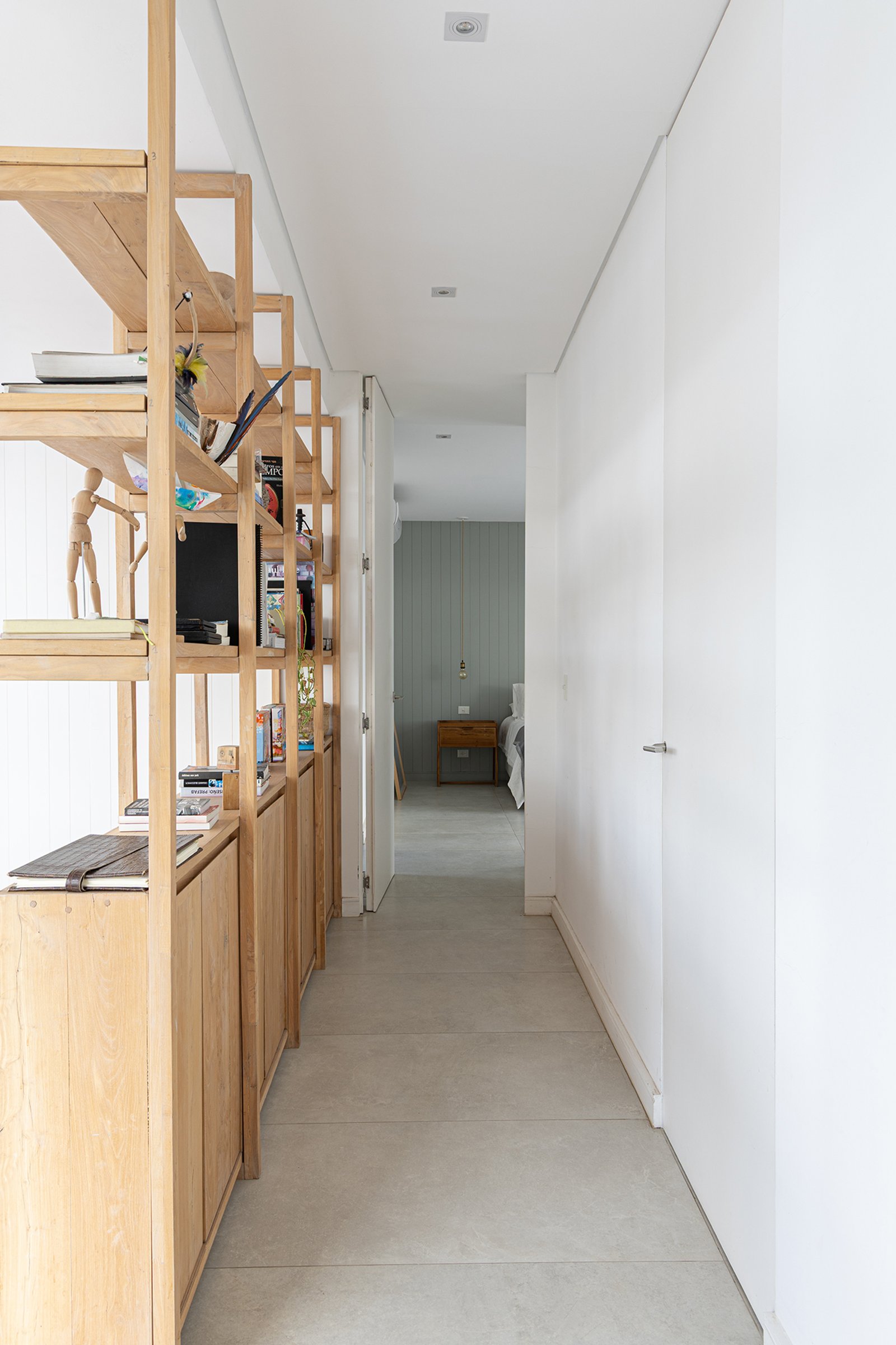 Corredor minimalista com prateleiras e móveis de madeira natural — projeto Casa Al Agua - Grupo PAUTA, por Gaby Alfonso, em Belén de Escobar