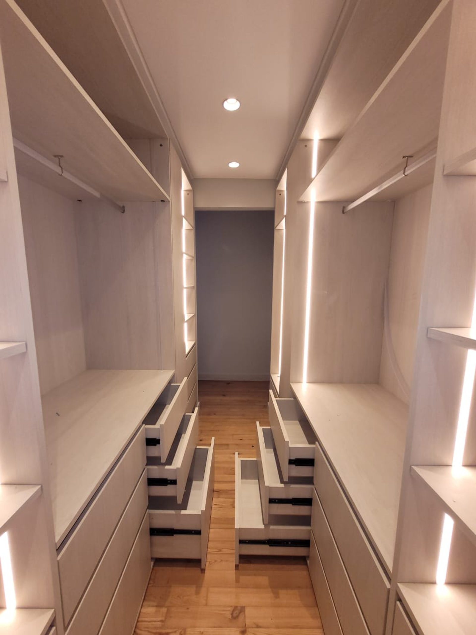 Vestidor moderno con almacenamiento integrado e iluminación LED sutil — proyecto Belgrano, por Licefe Carpentry SRL, en Belgrano
