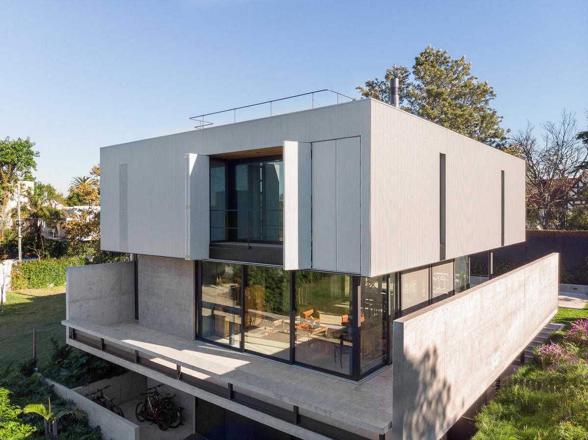 fachada moderna de concreto com grandes janelas — projeto Casa NTM, por BDB Arquitectos, em San Isidro