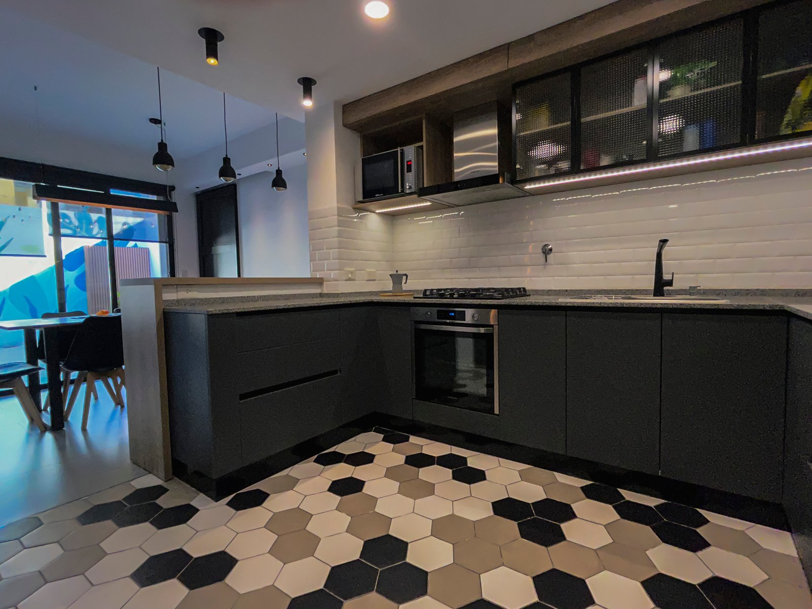 Cocina moderna con muebles grises oscuros y piso hexagonal — proyecto Vivienda Mari y Lean, por Jeitinho Estudió Creativo, en La Plata