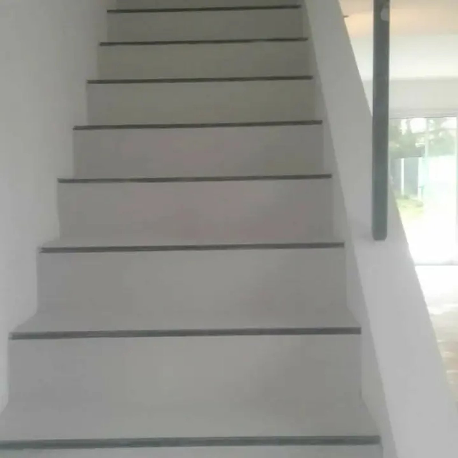 Escada moderna com degraus cinza e corrimão escuro — projeto Microcemento Diego orosco, por Microcemento alizados Dieguito, em Virrey del Pino