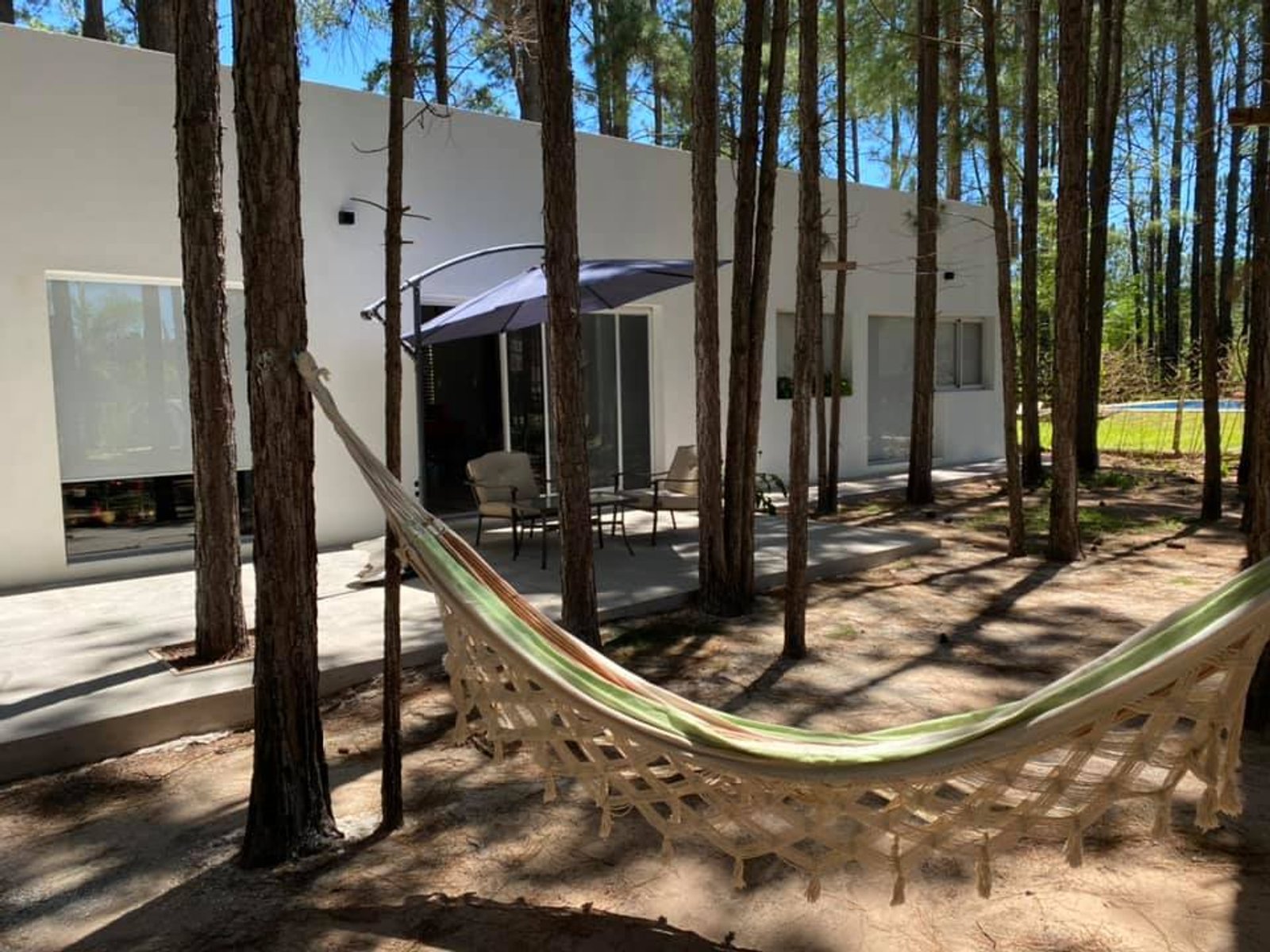 Casa moderna con hamaca entre pinos — proyecto Casa en el Bosque, por Arquitecto Gustavo Maidana, en Santa Ana de los Guácaras