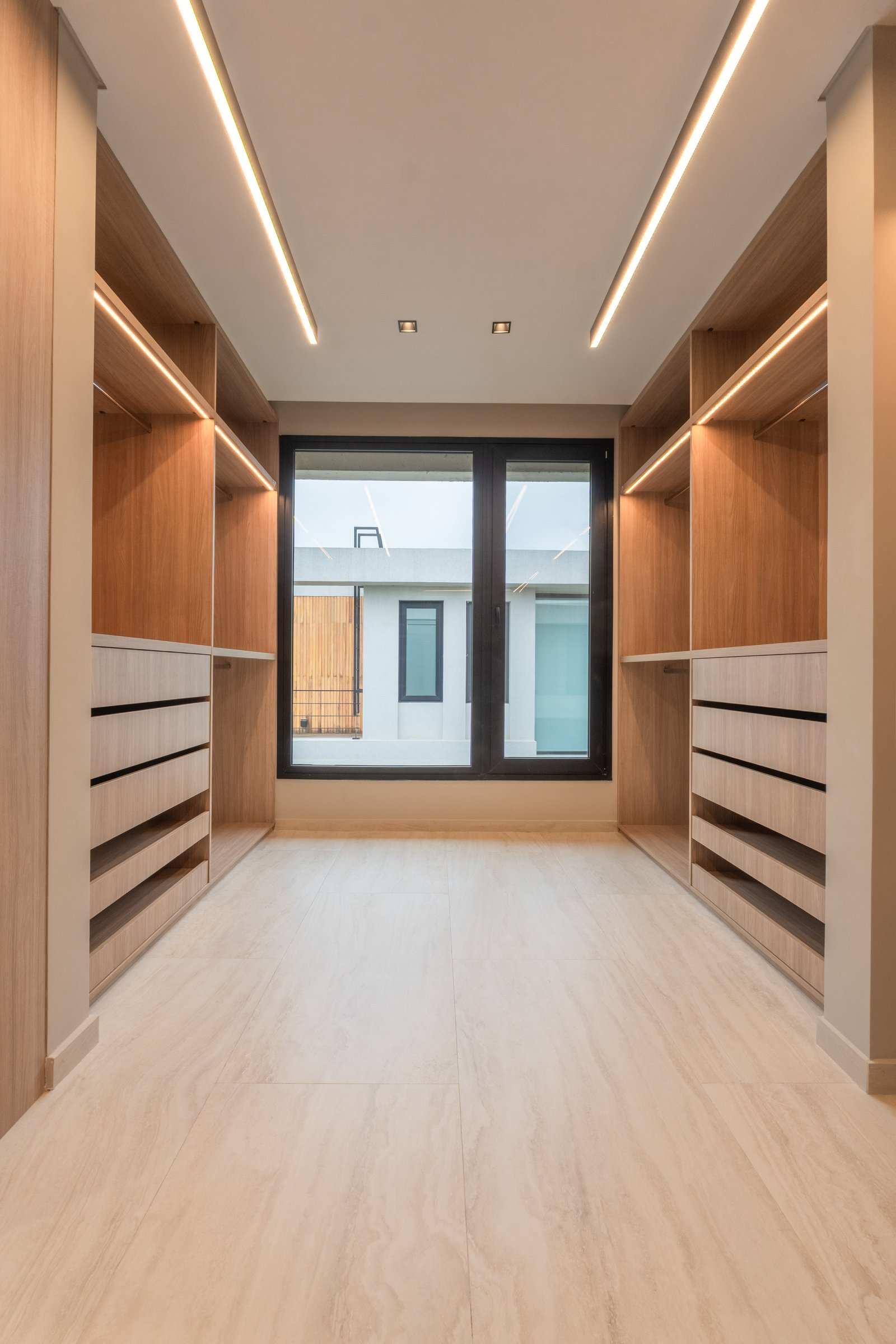 Moderna vestidor con carpintería de madera y gran ventana — proyecto Yacht - Estudio CCWay, por ABEJA CONCEPT, en Av. de la Ribera 560