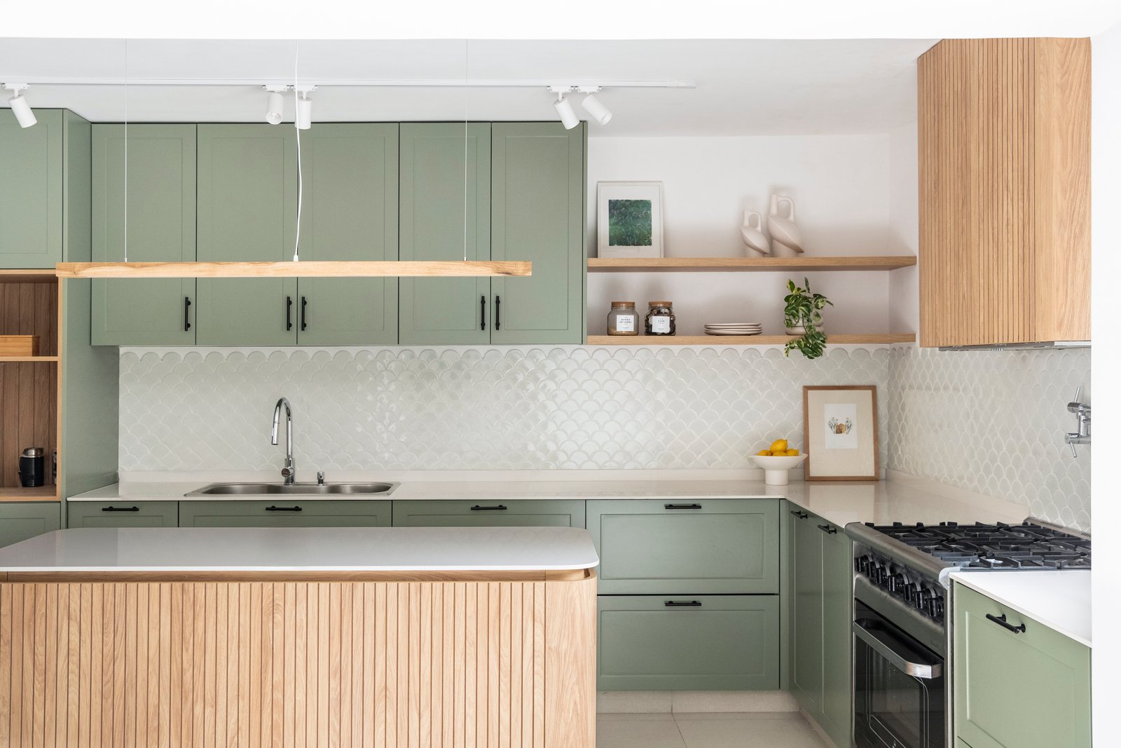 Cozinha escandinava moderna com ilha de madeira e armários verdes — projeto Ballester, por BK Arquitectos, em B1653 Villa Ballester