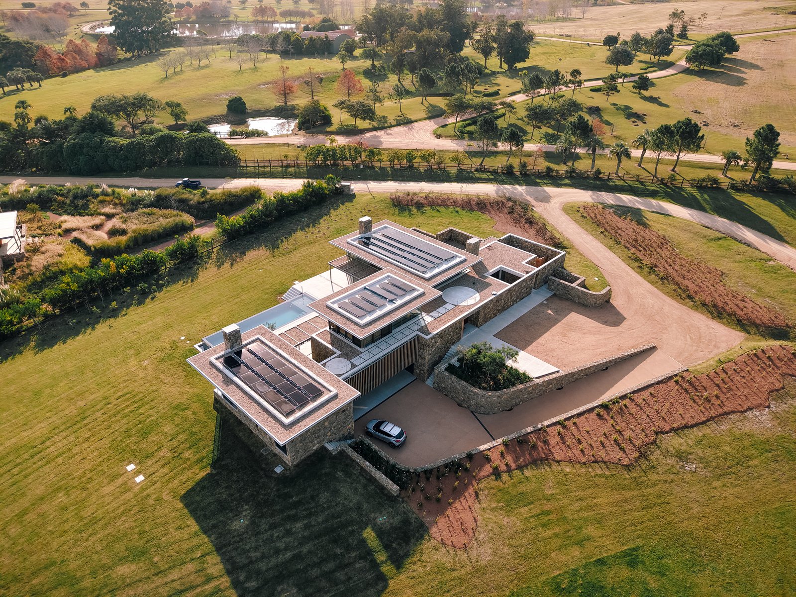 casa moderna com piscina e vegetação rural exuberante — projeto Laguna Estates, em Maldonado