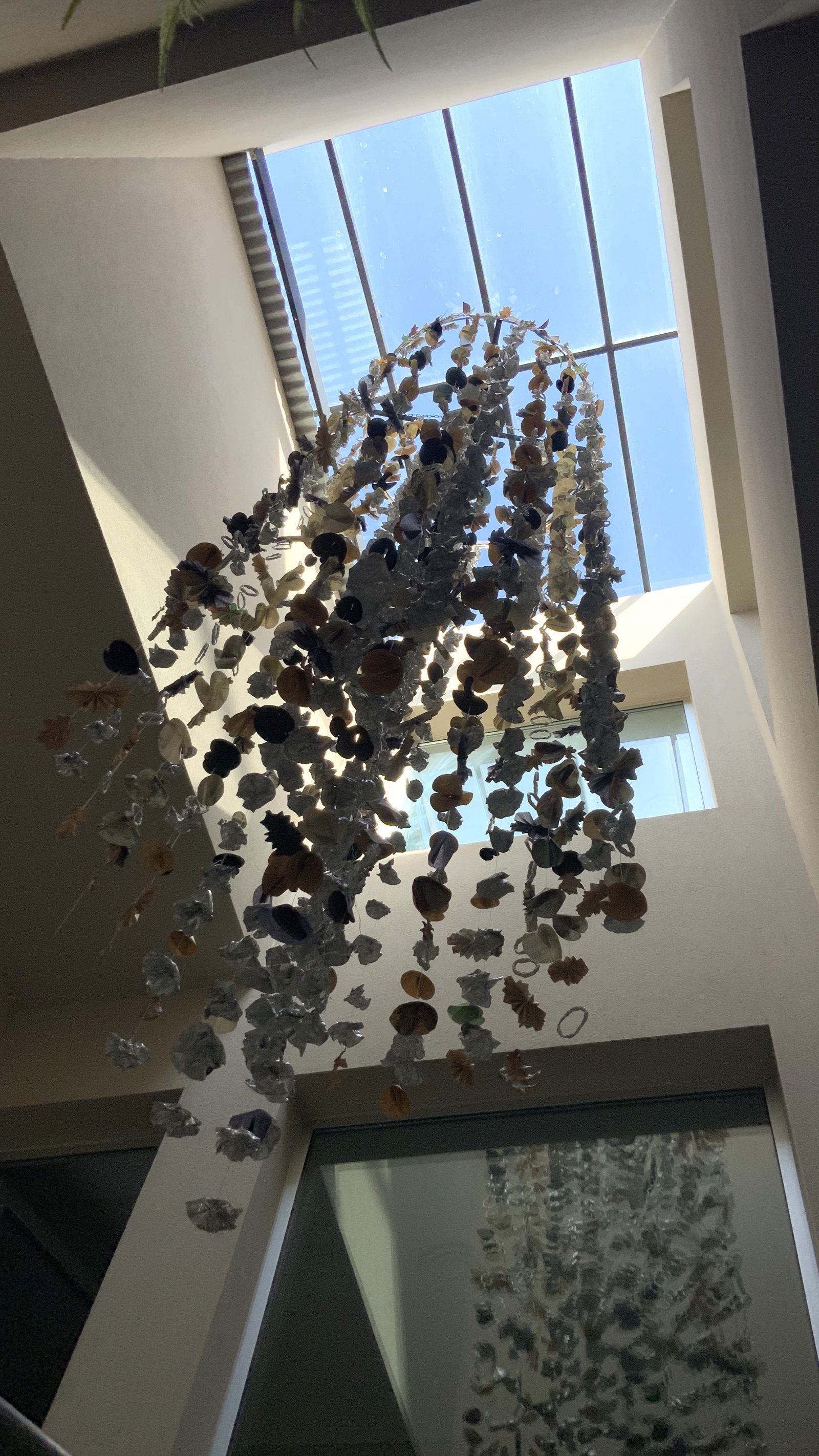 Escultura de caracoles colgante en atrio con tragaluz — proyecto Villa Isidro Hotel Boutique & Spa, por Hermann Arquitectos, en San Isidro