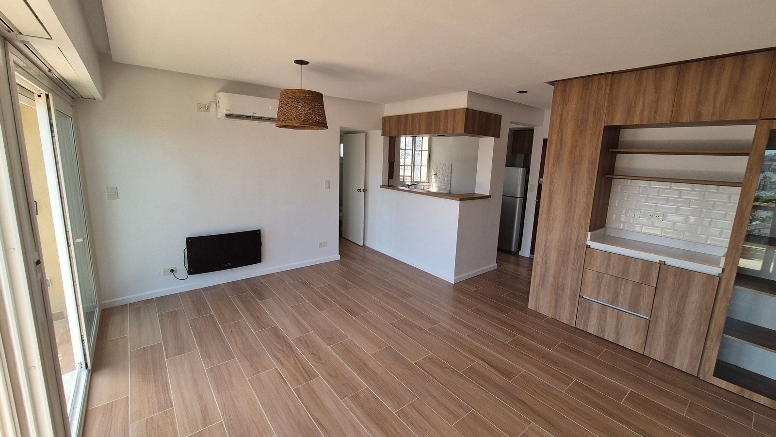 Sala de estar com cozinha integrada e armários de madeira — projeto Living - Remodelación Soho, por RenovArqui, em Palermo