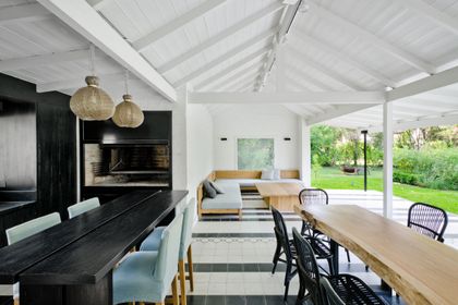 Comedor y quincho semi-cubierto con techo de madera a la vista — proyecto Casa BA, por Estudio Dado, en Pilar