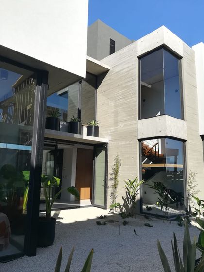 Casa contemporánea con fachada hormigón blanco y grandes ventanales — proyecto Virazon-01, por VGLA Arquitectos, en Nordelta