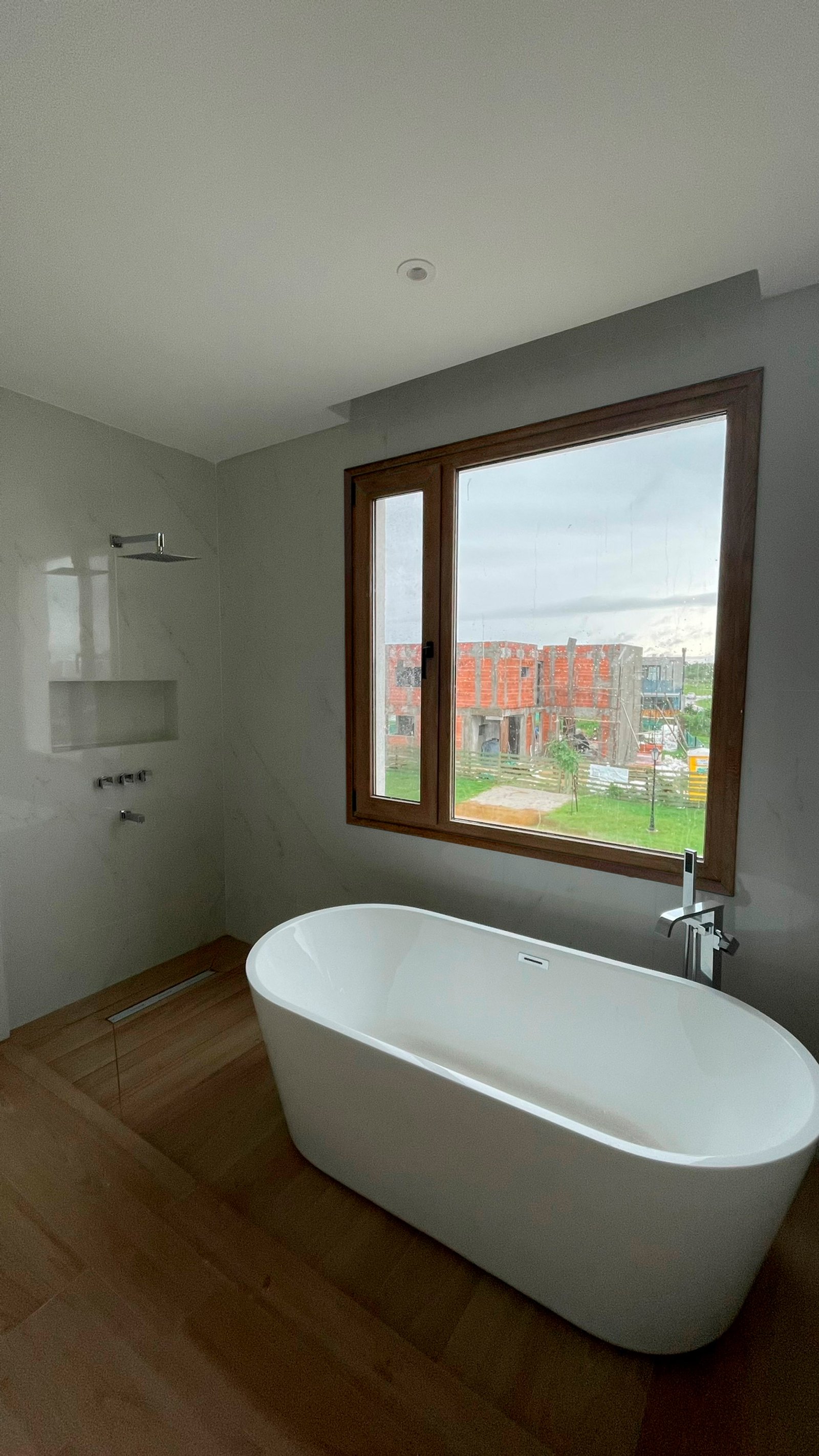 Baño moderno con bañera exenta y ventana grande — proyecto Casa ER , por Hermann Arquitectos, en Arribeños 1611
