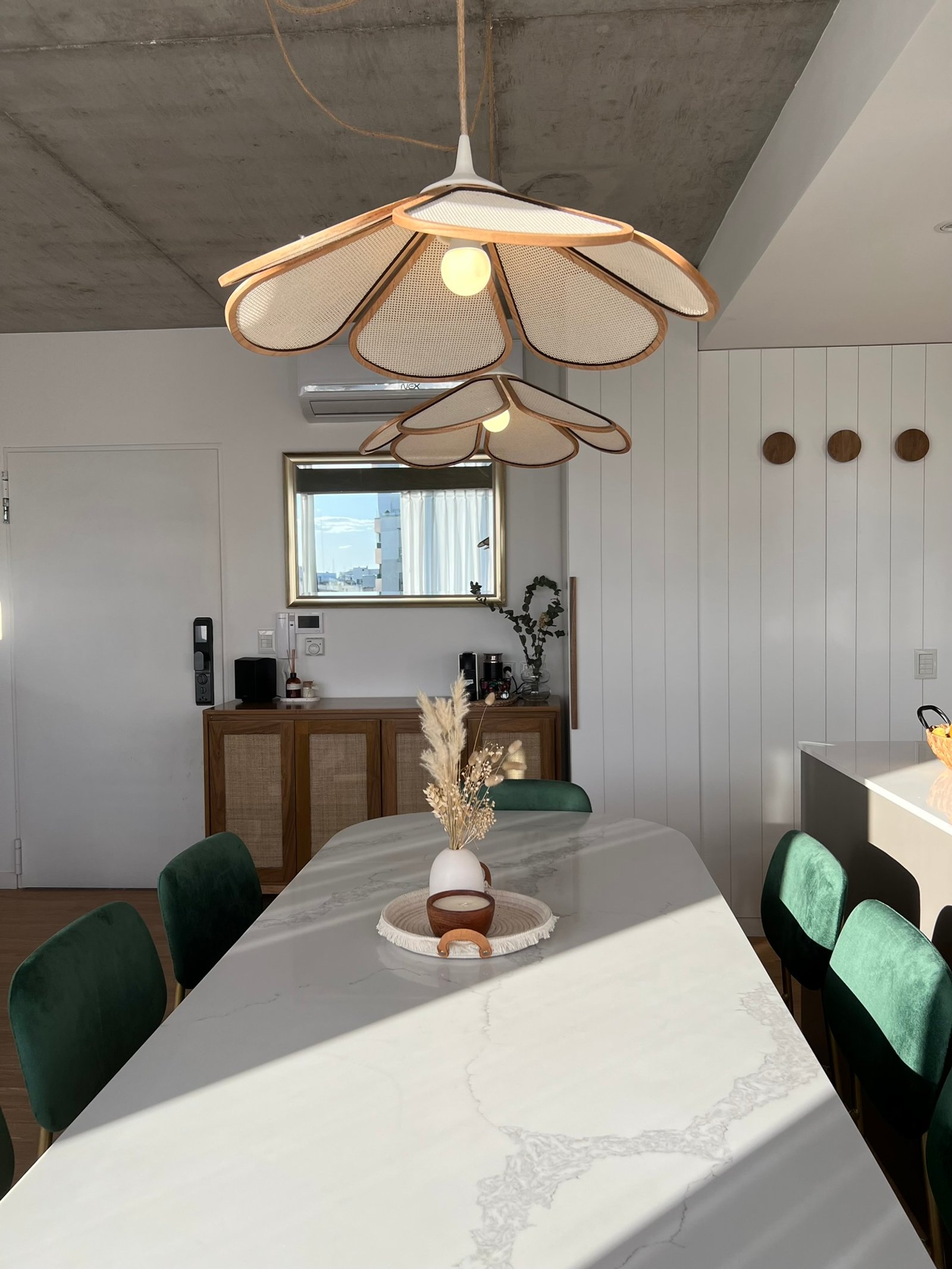 Comedor con luces colgantes florales, sillas de terciopelo verde y mesa de mármol — proyecto Velasco, por MDBK Arquitectura, en Villa Crespo
