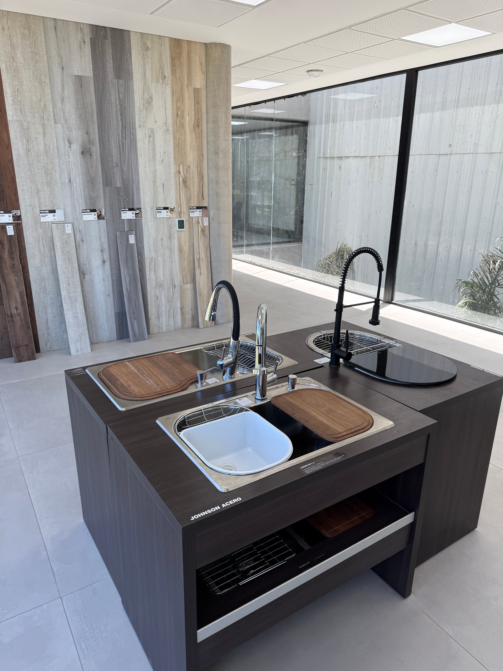 Cozinha moderna com ilha, painéis de madeira e múltiplas pias — projeto Showroom, por GAP HAUS, em Calle Austria Nte. 2450