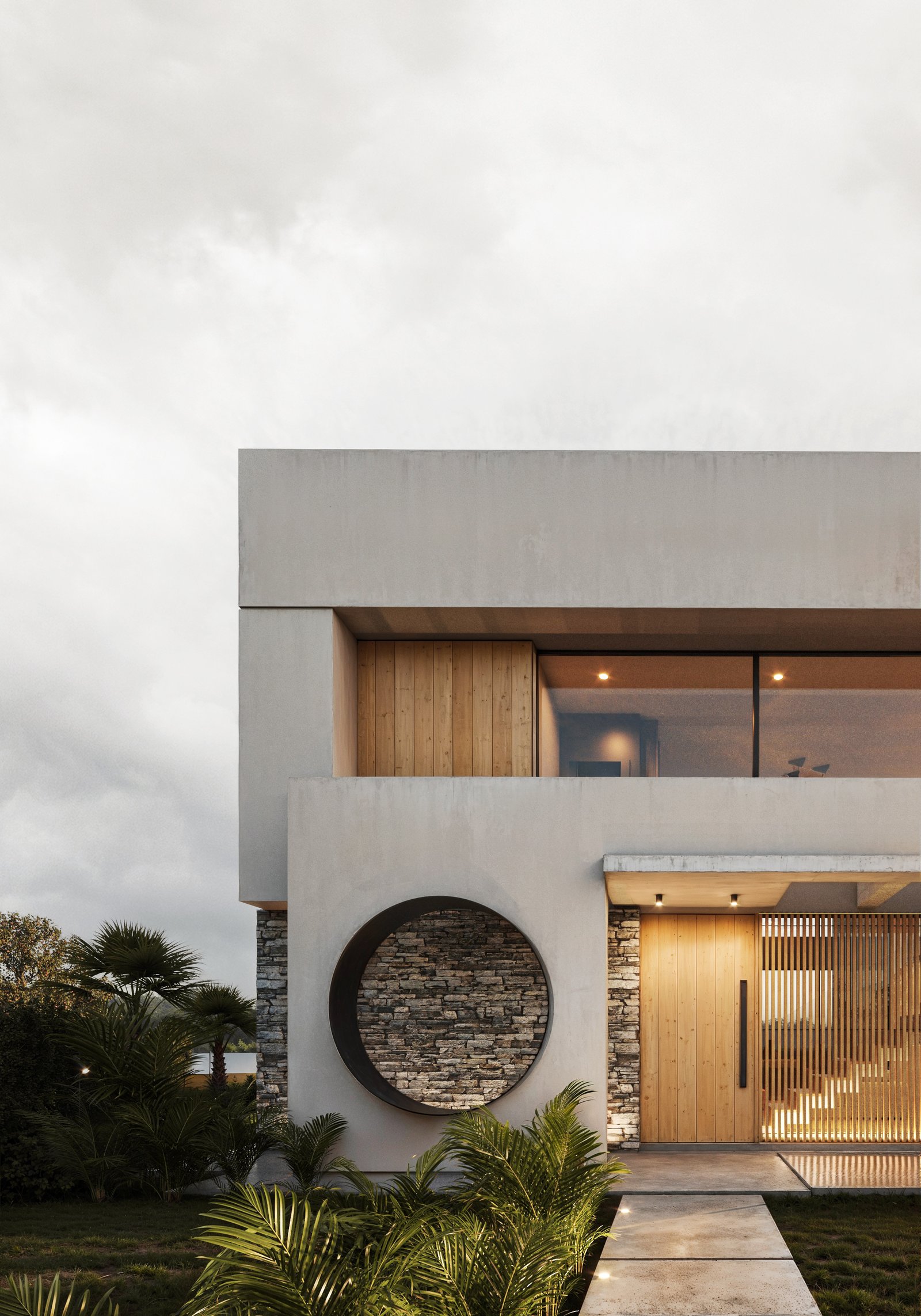 Fachada moderna con ventana circular de piedra y puerta de madera — proyecto Casa Linda, por LESSI ARQUITECTURA, en B2814 Los Cardales