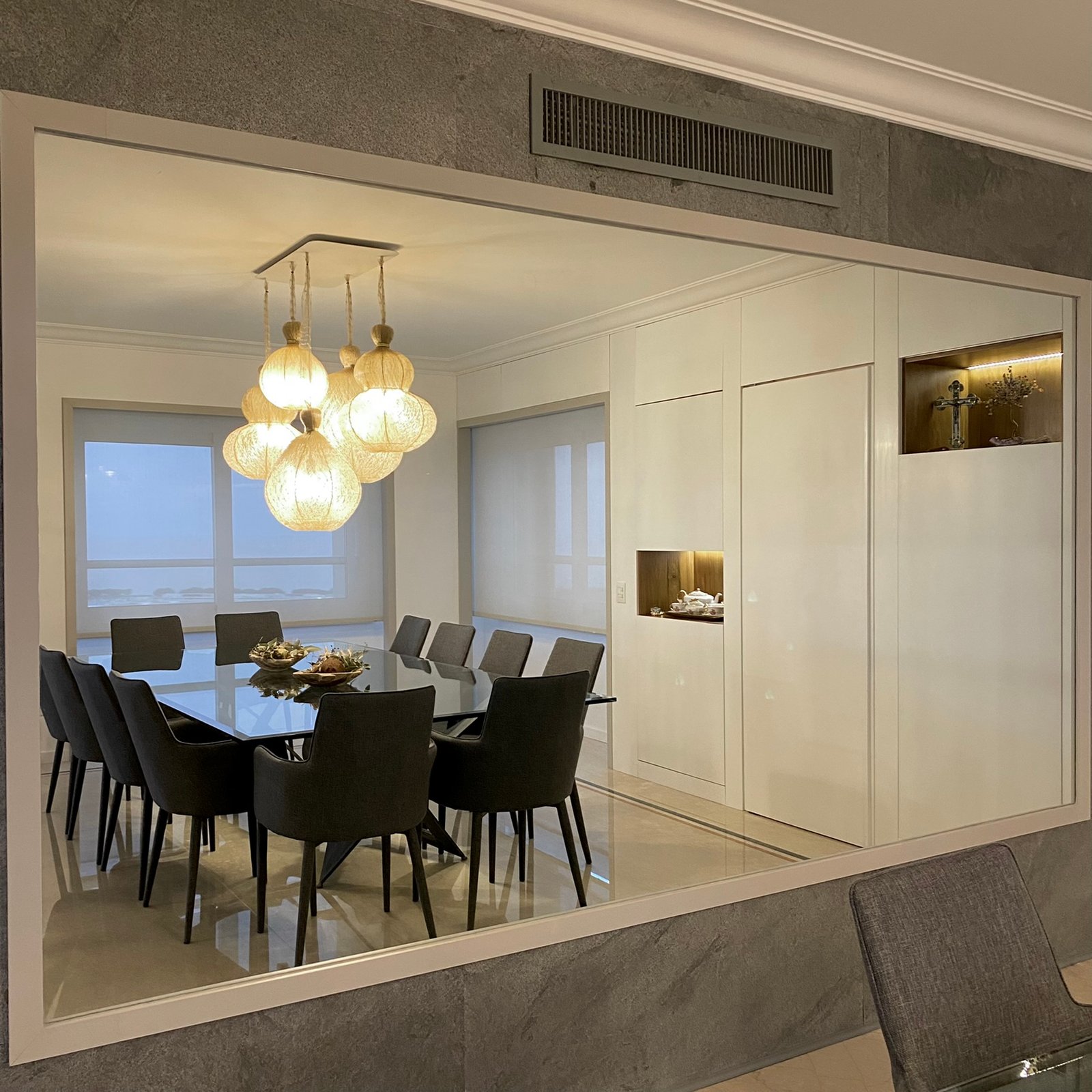 Comedor moderno con luces colgantes de mimbre y paneles de madera — proyecto Libertador I, por MDBK Arquitectura, en Palermo