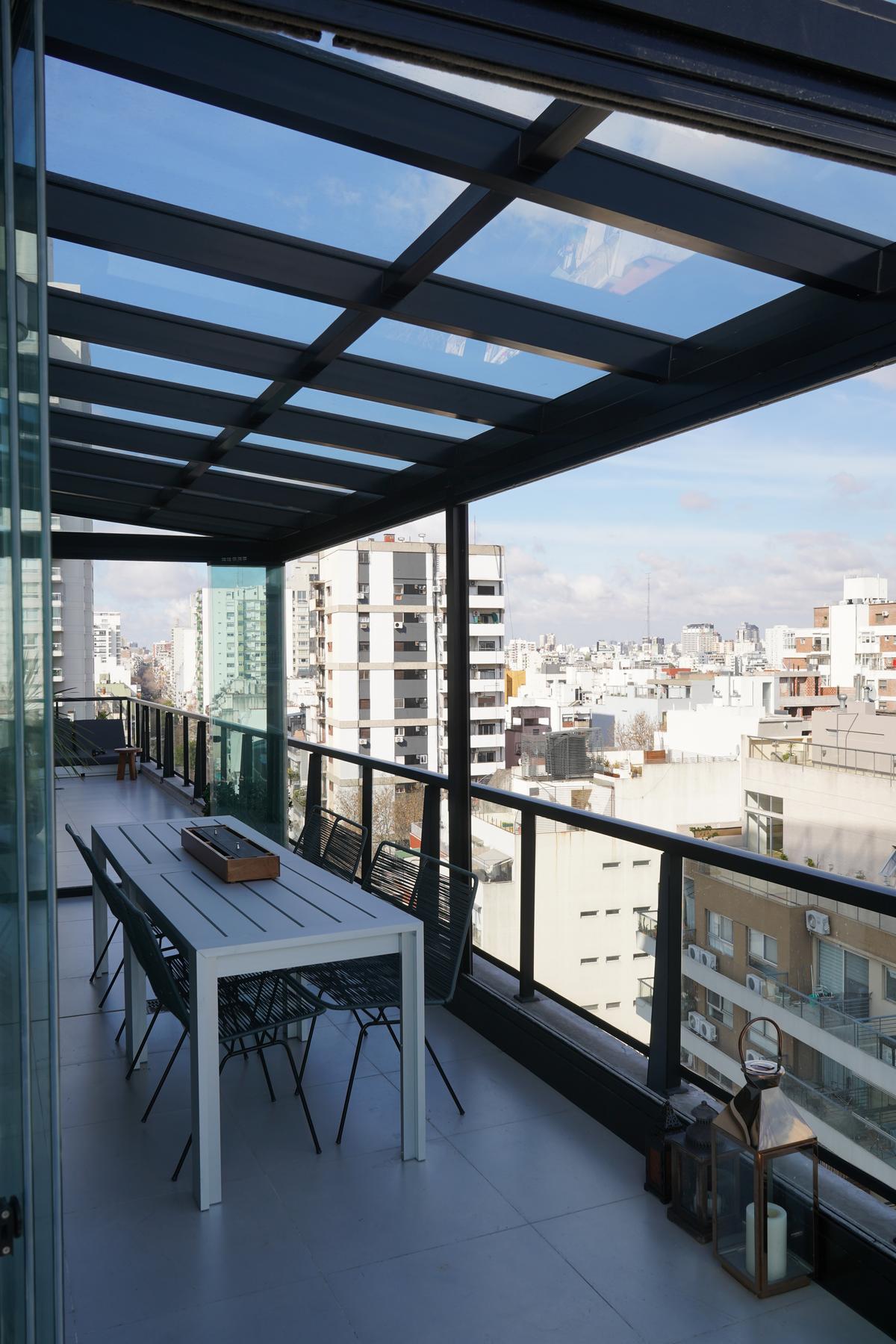 Terraço moderno com teto de vidro e vista da cidade — projeto TOLDER - TECHOS DE VIDRIO, por Argentina en Obra 2024, em Rincón de Milberg