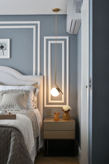 Dormitorio moderno con pared gris, cabecera blanca y lámpara colgante dorada — proyecto Apartamento DE, por Giovana Ciacco, en Guarulhos