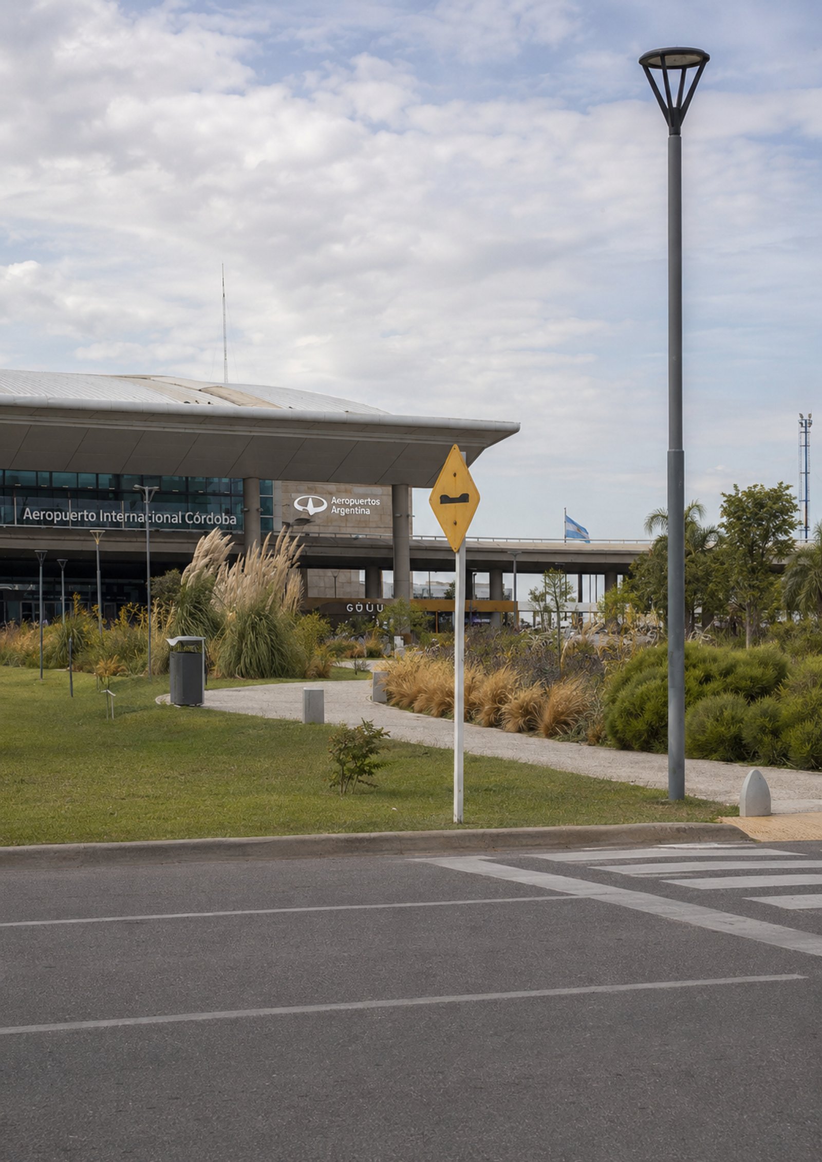 Aeropuerto de Córdoba con moderna fachada y farola distintiva — proyecto Aeropuerto Internacional Ing. Taravella :: Córdoba :: Paisajismo Institucional :, por STIPA Arte Natural, e