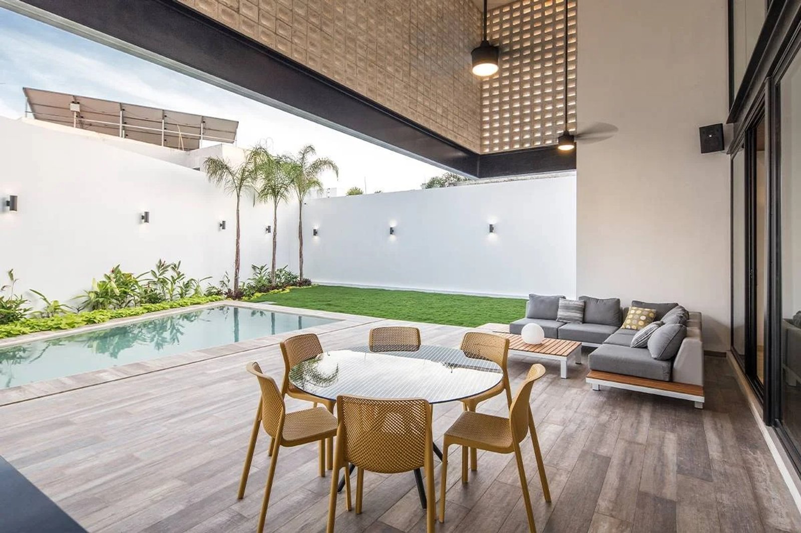 Luminoso patio moderno con piscina, sala y comedor al aire libre — proyecto Comedor, por Casa Nuñez