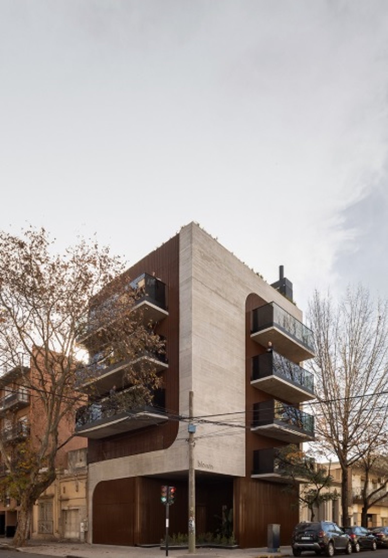 Edificio moderno con fachada de hormigón, madera y arcos — proyecto EDIFICIO PATRIMONIO, por DIB OBRIST Arquitectas, en Rosario