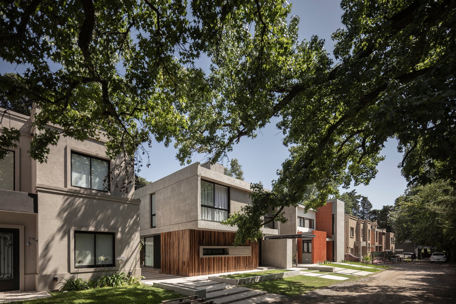 fachada moderna com árvores e concreto — projeto Casa Emilia, por Grupo CRBN, em Parque Leloir