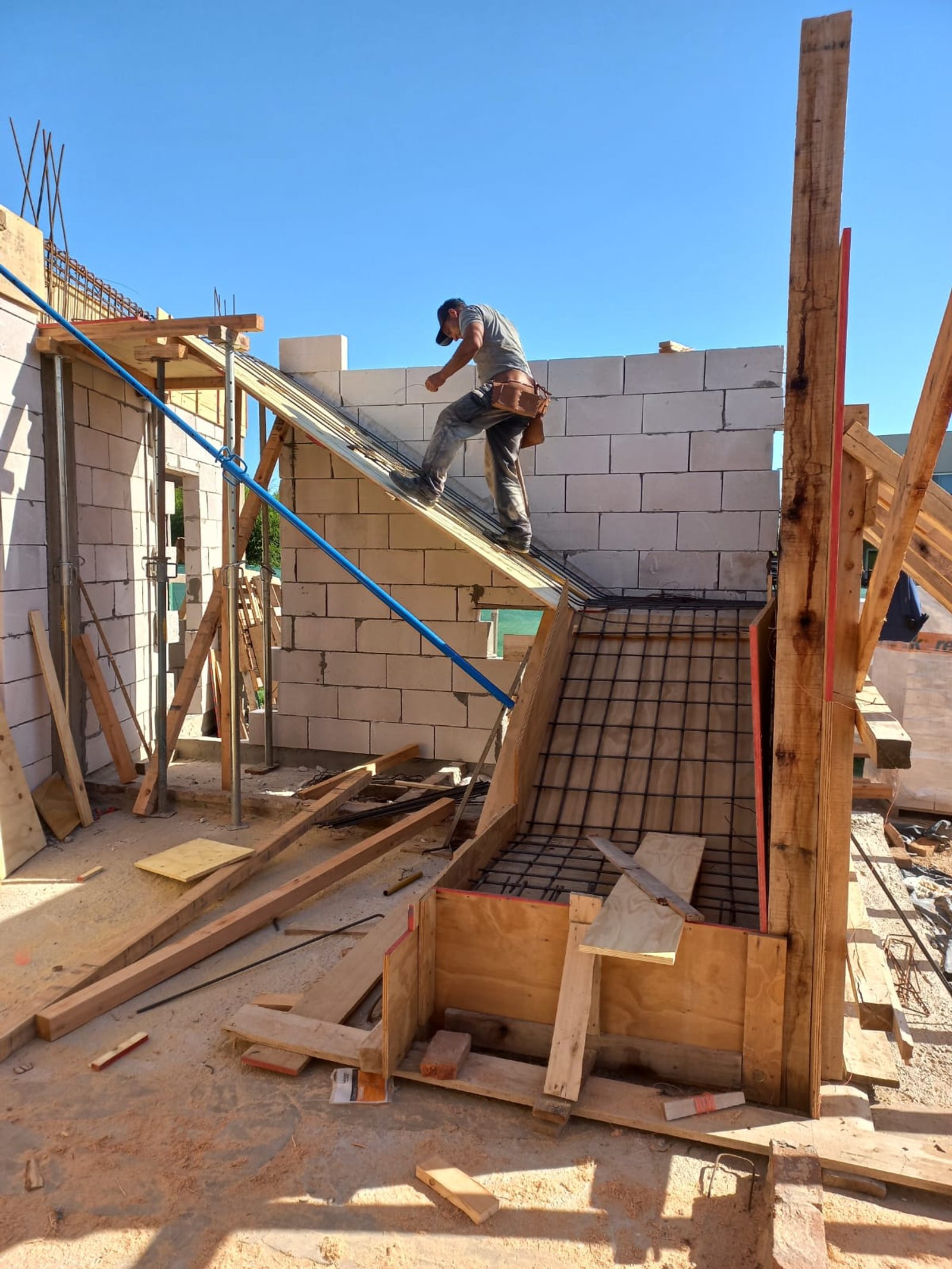 obra en construcción, ladrillos blancos y andamios de madera — proyecto EL CANTON, por Estudio Demares, en Belén de Escobar