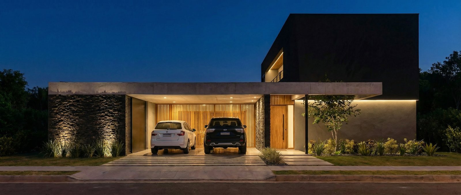 Casa moderna de noche con volúmenes oscuros y luz indirecta — proyecto Casa JR, por Pedro Vilchez, en Plottier