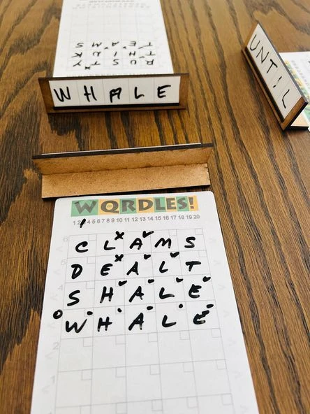 Cover image of WQRDLES: A Tactile Wordle-Like Multi-Player Word Deduction Game board game