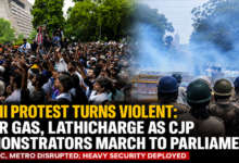 Security personnel use tear gas and barricades to stop CJP protesters marching towards Parliament in New Delhi during the Monsoon Session.