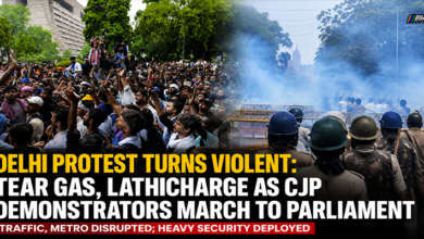 Security personnel use tear gas and barricades to stop CJP protesters marching towards Parliament in New Delhi during the Monsoon Session.