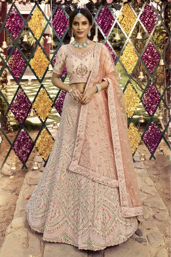 Bridal lehenga paired with peach color heavily embellished choli and peach  color net heavy embroidered border in peach and maroon color .|lovelyweddingmall.com|