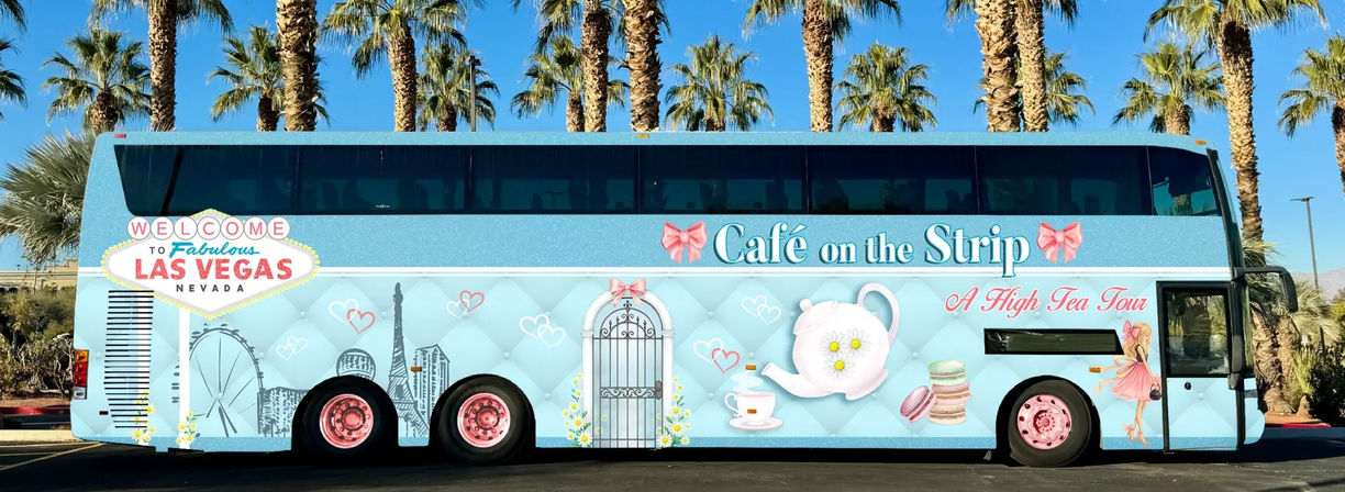 Light-blue double-decker tour bus on the Las Vegas Strip under palm trees, decorated with high‑tea graphics — teapot, teacup, macarons, skyline and welcome sign.