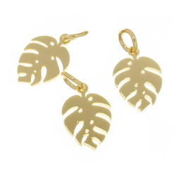 Three shiny gold Monstera leaf pendant charms with cutout details and jump rings on a white background, tropical jewelry accent