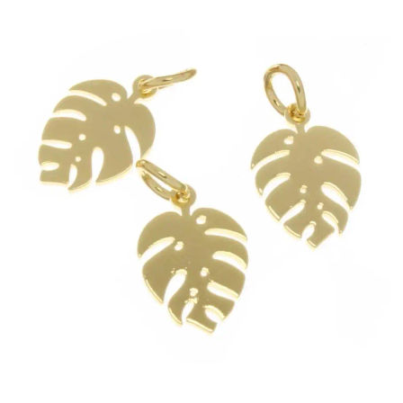Three shiny gold Monstera leaf pendant charms with cutout details and jump rings on a white background, tropical jewelry accent