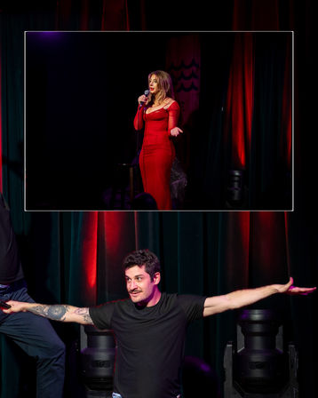 Live stage performance with a woman in a red gown singing into a microphone in an upper framed shot, and a man in a black t‑shirt with a tattooed arm striking a wide‑armed pose below against red‑lit curtains.