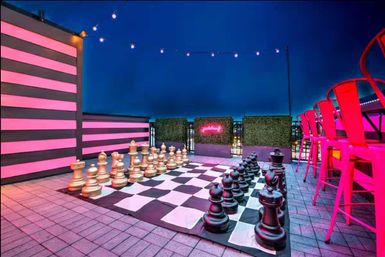 Rooftop Royale: 20 Beds + Rooftop Lounge with Large Chess, Fire Pit + Bar image 4