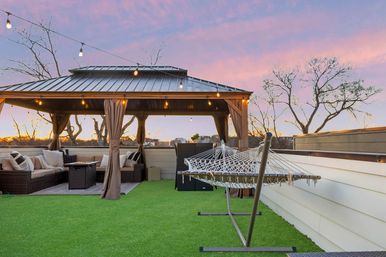 The Lyric: Modern 4-Bedroom Retreat with Rooftop Access and Fire Pit image 4