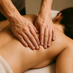 Hands performing a relaxing back massage on a person at a spa — soothing wellness and massage therapy treatment.