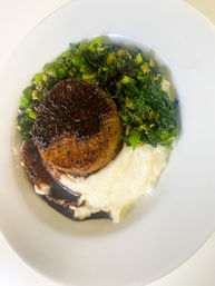 Seared mushroom medallion with balsamic glaze atop creamy mashed potatoes and sautéed greens on a white plate — restaurant-style gourmet comfort dish.
