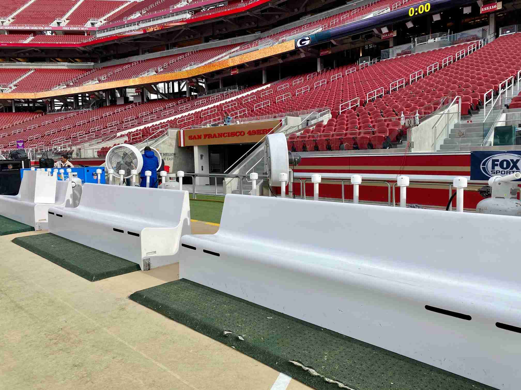 White colored Empty heated benches in an empty football stadium