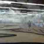 A man standing in between OC-Raceway Misting System