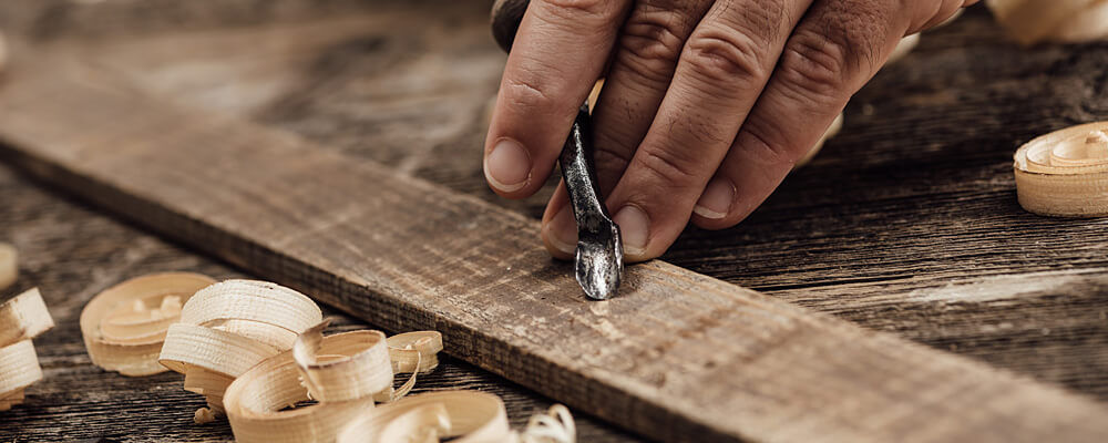 carving and sanding a wooden table