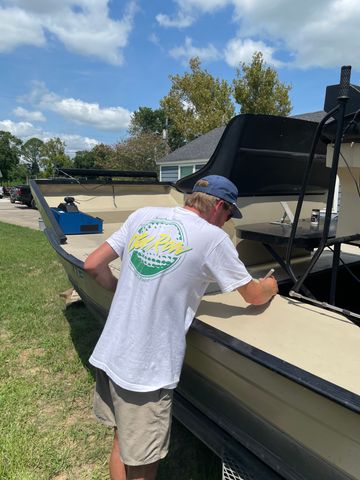 Technician templating airboat interior for custom marine flooring