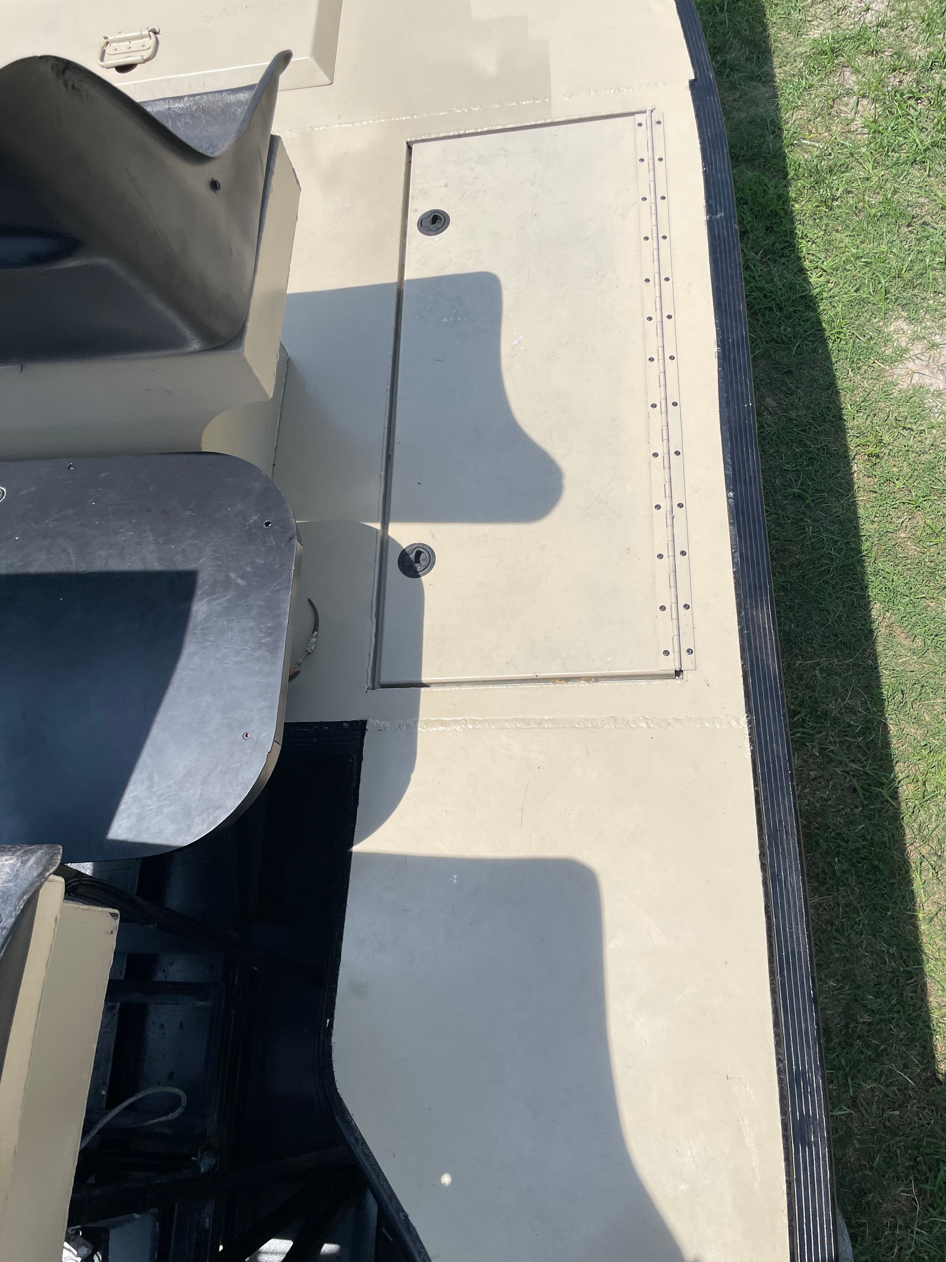 Airboat helm station deck with integrated storage hatch