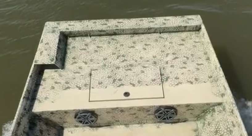 Camo skiff on the water — custom gator-skin finish and deck layout