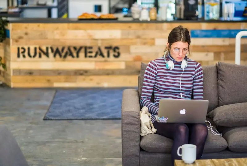 Lady working on her laptop at Runway East