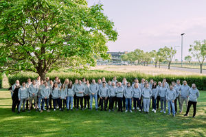 Team photo of Bluecode employees wearing Bluecode hoodies