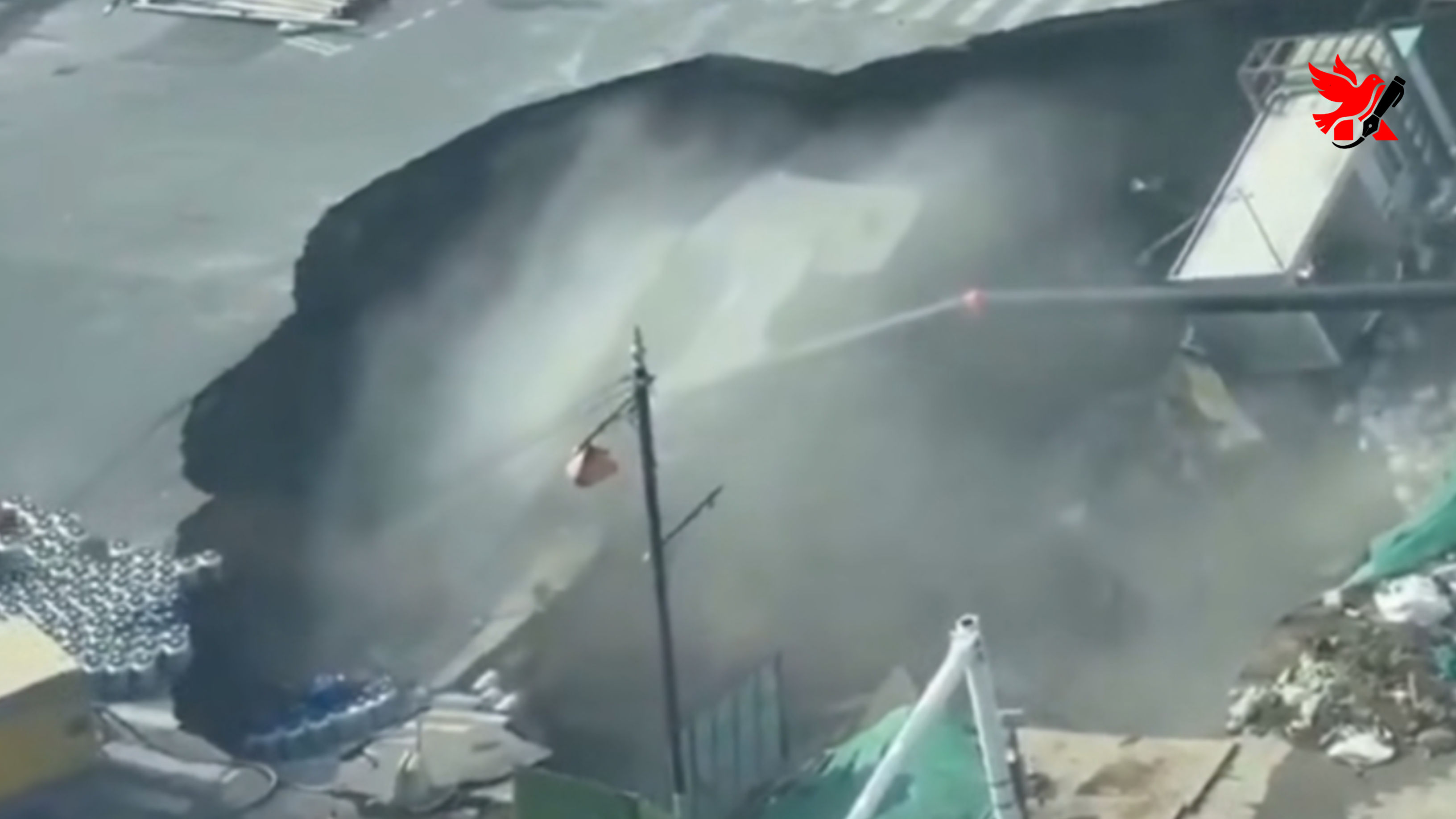 Penampakan lubang raksasa (sinkhole) yang menganga di tengah jalan raya Distrik Minhang, Shanghai, memperlihatkan reruntuhan bangunan dan aspal yang amblas ke dalam tanah.